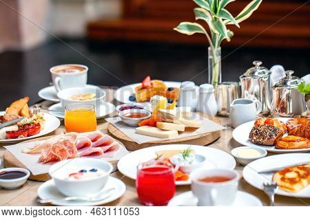 Brunch Or Lunch In Luxury Restaurant. Table Full Of Delicious Food - Cheese, Salmon, Ham, Bakery And