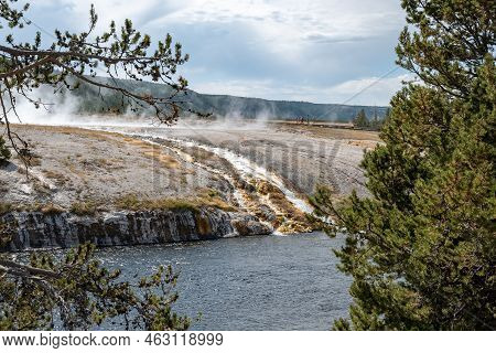 Smoke Emitting From Hotspring By Firehole River In Midway Geyser Basin At Park