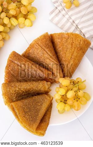 Grape Pastille And Green Grapes On White Plate, Top View. Homemade Georgian Tklapi.