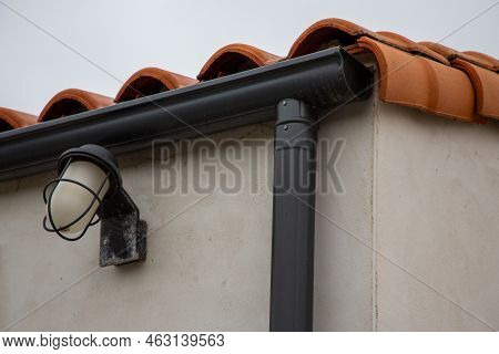 House With New Seamless Aluminum Rain Gutters With Vintage Facade Lamp Light Outdoor