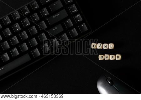 Game Over Inscription Next To A Black Mechanical Keyboard And A Black Computer Mouse. Gambling And T