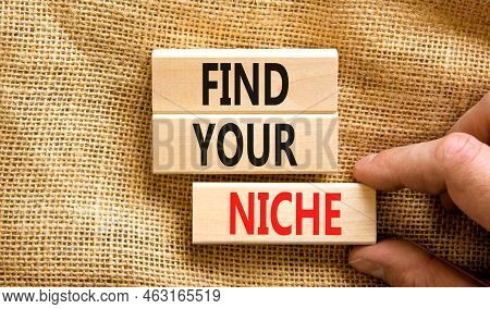 Find Your Niche Symbol. Concept Words Find Your Niche On Wooden Blocks. Businessman Hand. Beautiful 