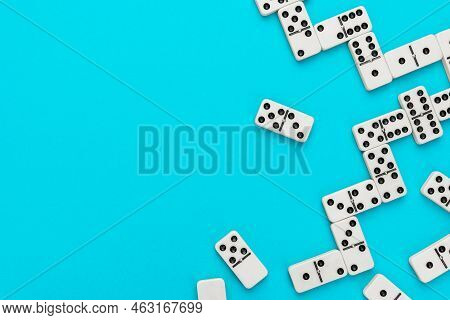 Domino Pieces On Turquoise Blue Background. Photo Of Domino With Copy Space. Minimalist Photo Of Som