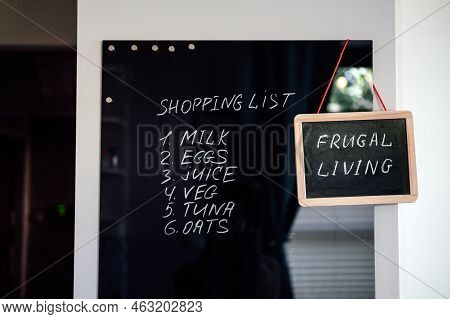 Frugal Living, Save Money, Live Cheap Concept With Shopping List On Letterboard And Frugal Living Te