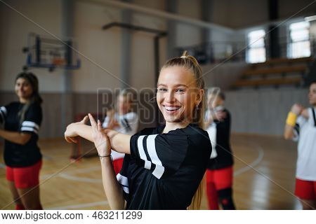 Group Of Multiaged Women, Sports Team Players. In Gym Stretching, Warming Up Before Match.