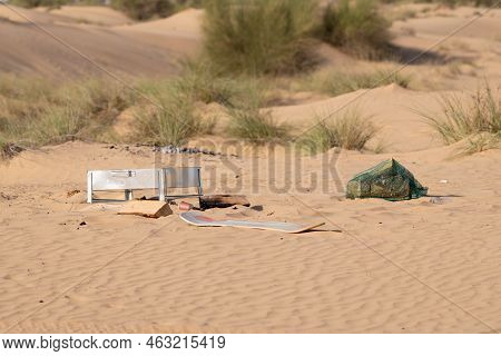 Metal, Plastic And Other Rubbish And Trash Left Behind By Humans Polluting The Desert Environment In