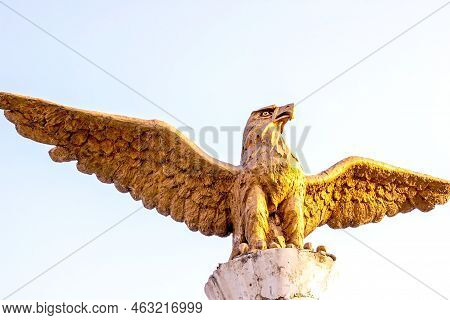 Dushanbe, Tajikistan - July 2, 2022: The Statue Of Golden Brazen Eagle Against The Sky.