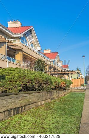 Residential Building With Red Roofs And Hedge Row On Land Terrace