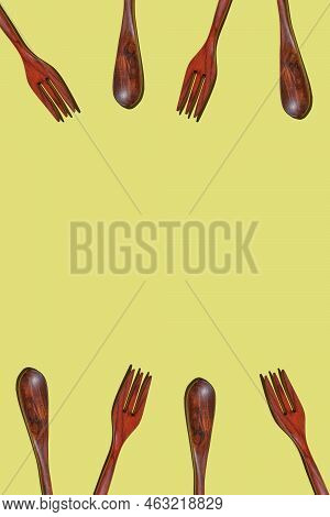 Top View On Many Bamboo Spoons And Forks On A Yellow Background, Eco Tableware, Disposable Cutlery, 