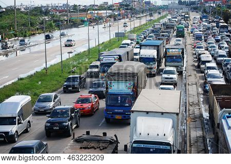 Thai People Riding Motorcycle And Driving Car On Street While Water Flood Or Inundation Road With Ve