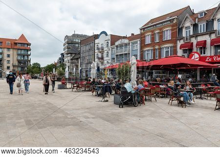 De Panne, West Flanders Region - Belgium - 07 16 2021 - Families And People Walking At The Beach Bou