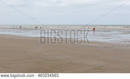 De Panne, West Flanders Region - Belgium - 07 16 2021 - View Over An Almost Empty Beach With Calm Wa