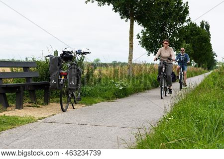 Veurne, West Flanders Region - Belgium - 07 18 2021 Recreative Cycling Path With Biking Couple