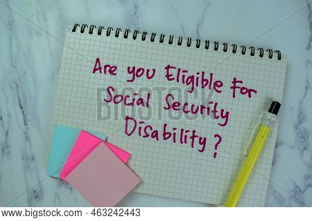 Concept Of Are You Eligible For Social Security Disability Write On A Book Isolated On Wooden Table.