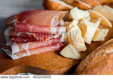 Wooden Board With Cheese And Ham. Board With Jamon And Cheese. Aperitif On The Board. Jamon With Bru