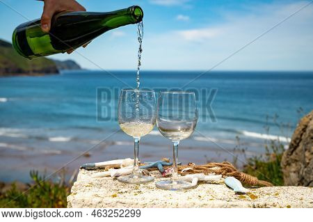 Pouring Of Txakoli Or Chacolí Slightly Sparkling Very Dry White Wine Produced In The Spanish Basque