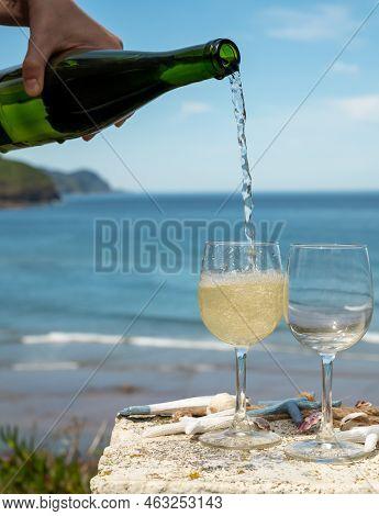 Pouring Of Txakoli Or Chacolí Slightly Sparkling Very Dry White Wine Produced In The Spanish Basque