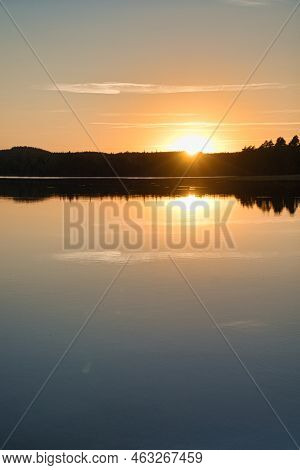 Sunset With Reflection On A Swedish Lake In Smalland. Romantic Evening Mood. Landscape Shot From Sca