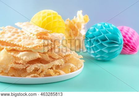 Sfrappole Or Chiachiere Or Angel Wings On A Bright Blue Background. Italian Carnival And Typical Foo