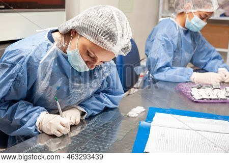 Scientist Preparing Paraffin Blocks Containing Biopsy Tissue For Sectioning. Pathology Laboratory. C