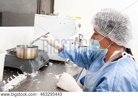 Scientist Embedding Tissues In Paraffin Blocks For Sectioning. Pathology Laboratory. Cancer Diagnosi
