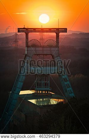 Vertical Shot Of A Headframe Tower With A Golden Sun Setting In The Background In Herten, Germany
