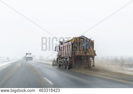 Snowplow Truck Removing Dirty Snow From City Street Or Highway After Heavy Snowfalls. Traffic Road S