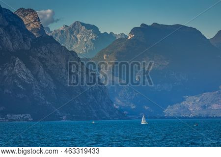 Sailing Alone In Lake Garda With Dramatic Landscape Near Riva Del Garda, Northern Italy