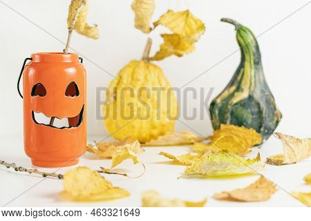 One Small Green Decorative Pumpkin, Leaves And Scary Pumpkin Candle Holder On White Background. Fall