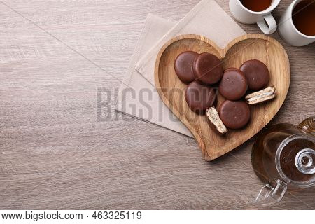 Tasty Choco Pies And Tea On Wooden Table, Flat Lay. Space For Text