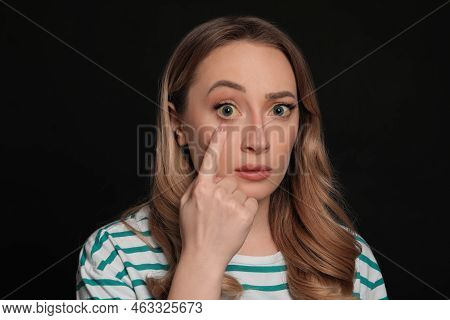Woman With Yellow Eyes On Black Background. Liver Problems Symptom