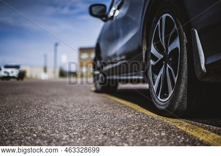 Selective Focus On Bad Parking Of A Vehicle On The Line Taking Up Two Spaces.