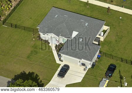 Aerial View Of Typical Contemporary American Private House With Roof Top Covered With Asphalt Shingl