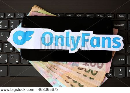 Ternopil, Ukraine - September 6, 2022 Onlyfans Paper Logotype On Bunch Of Ukrainian Hryvnias Bills L