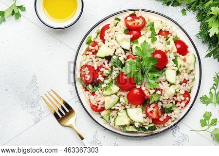 Bulgur Tabbouleh Salad With Fresh Tomatoes, Cucumbers And Parsley. Traditional Middle Eastern And Ar