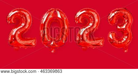 Golden Foil Balloons With The Number 2023. Happy New Year And Christmas Holiday Concept. Top View Co
