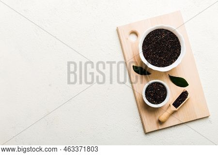 Quinoa Seeds In Bowl And Spoon On Colored Background. Healthy Kinwa In Small Bowl. Healthy Superfood
