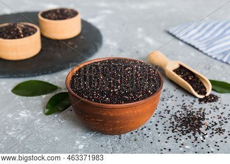 Quinoa Seeds In Bowl And Spoon On Colored Background. Healthy Kinwa In Small Bowl. Healthy Superfood