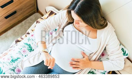 Pregnant Clock Time Childbirth. Childbirth Time, Contractions Pain. Pregnancy Woman Watching Clock, 