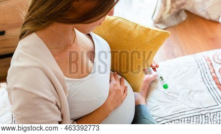 Pregnancy Fever Temperature Check. Pregnant Woman Holding Thermometer, Check Fever Flu Temperature. 