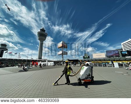 Schiphol, Netherlands - June 12 2022: Passengers Walking Outside The Terminals Of The Airport With A