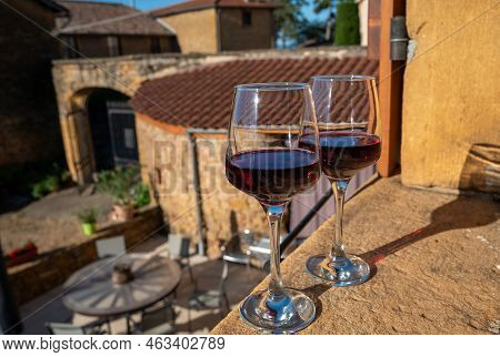 Tasting Of Red Wine By Old Wine Maker In Pierres Dorées Region With Yellow Stone Houses On South Of