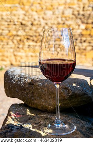 Tasting Of Red Wine By Old Wine Maker In Pierres Dorées Region With Yellow Stone Houses On South Of