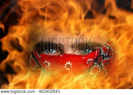 Defocus Young Man In Red Bandana. Closeup Blue Dark Eyes. Man With His Face Hidden Behind A Bandanna