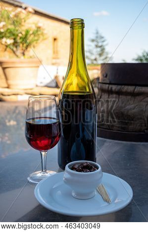 Tasting Of Red Wine By Old Wine Maker In Pierres Dorées Region With Yellow Stone Houses On South Of