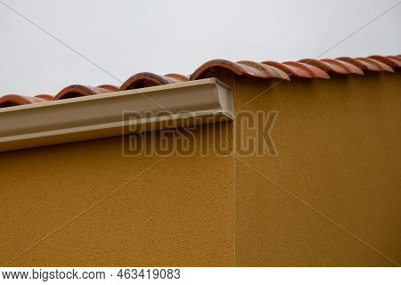 A Brown Aluminium Gutter System Against Sky