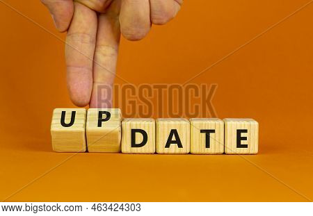 Date Or Update Symbol. Businessman Turns Wooden Cubes And Changes The Concept Word Date To Update. B