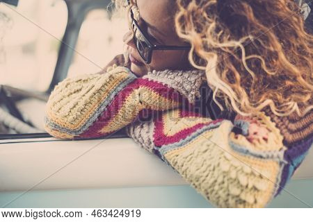 Portrait Of Beautiful Sweet Curly Caucasian Young Woman Looking At Her Side Out Of The Windoe Of The