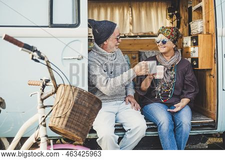 Happy Cheerful Mature People Couple Caucasian Traceler Enjoy And Take A Break Resting Sit Down Out O