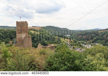 Panorama View Of Ruins Of Castle Loewenburg On A Hill Spur And Eifel Village Monreal, Germany